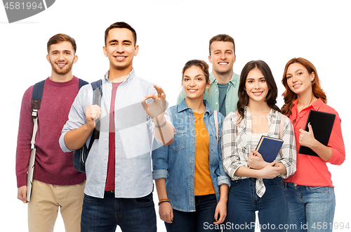 Image of group of smiling students showing ok hand sign