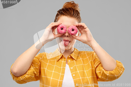 Image of funny teenage girl with donuts instead of eyes