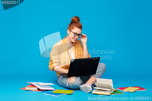 Image of red haired teenage student girl with laptop