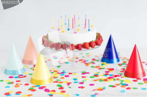 Image of birthday cake with candles and strawberries