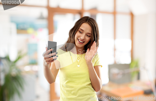 Image of smiling teenage girl having video call smartphone
