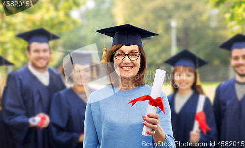 Image of happy senior graduate student woman with diploma