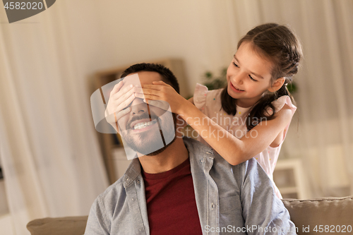 Image of happy father and little daughter playing at home