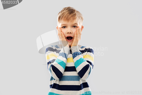 Image of shocked little boy in striped pullover