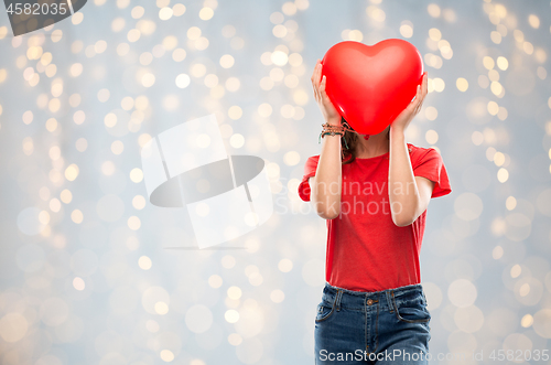 Image of teenage girl with red heart shaped balloon