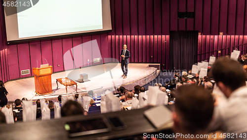 Image of Speaker giving presentation on business conference event.