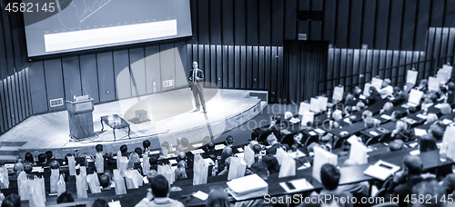 Image of Speaker giving presentation on business conference event.