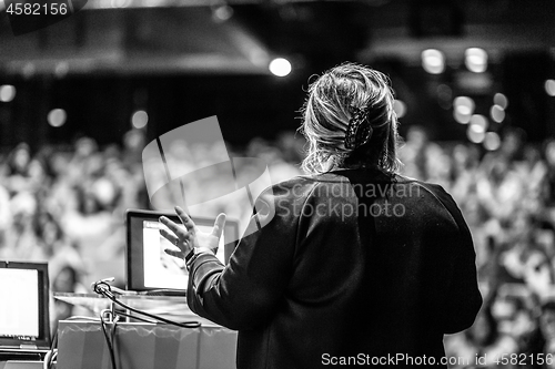 Image of Public speaker giving talk at Business Event.