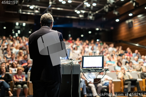 Image of Public speaker giving talk at Business Event.