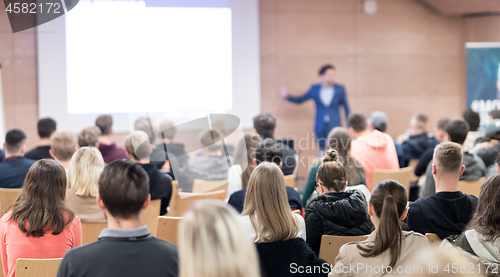 Image of Business speaker giving a talk at business conference event.