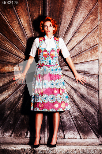 Image of Portrait of a young redheaded woman in a dirndl