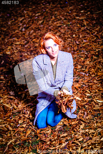 Image of portrait of beautiful young woman in autumn