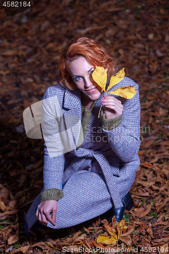 Image of Portrait of a smiling young woman in autumn