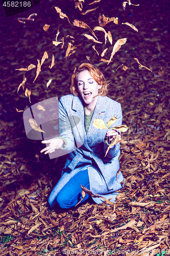 Image of Portrait of a woman with autumn leaves.