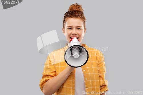 Image of red haired teenage girl speaking to megaphone