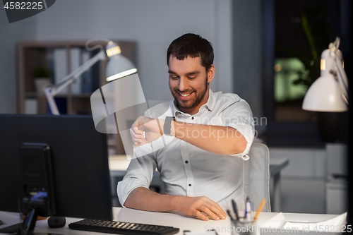 Image of businessman using voice command on smart watch