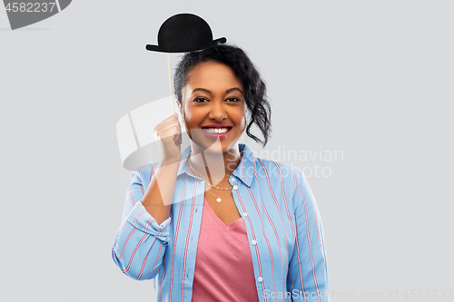 Image of african woman with bowler hat party accessory