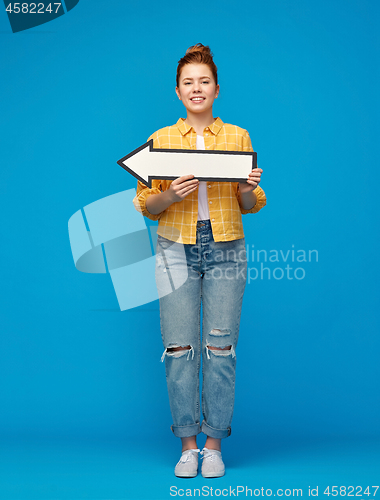 Image of red haired teenage girl with arrow showing to left