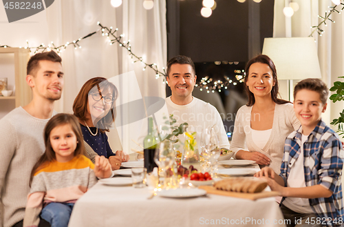 Image of happy family having dinner party at home