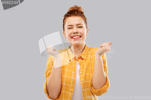 Image of happy red haired teenage girl celebrating success