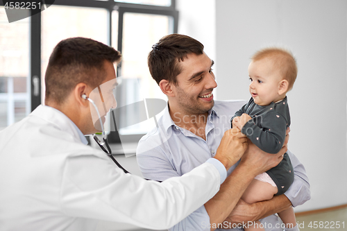 Image of father with baby and doctor at clinic