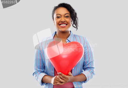 Image of african american woman with heart-shaped balloon