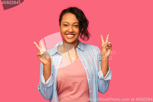 Image of happy african american woman showing peace