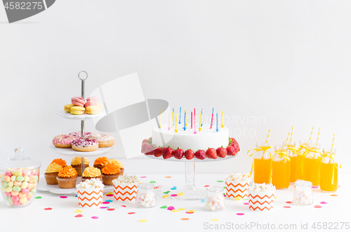 Image of food and drinks on table at birthday party