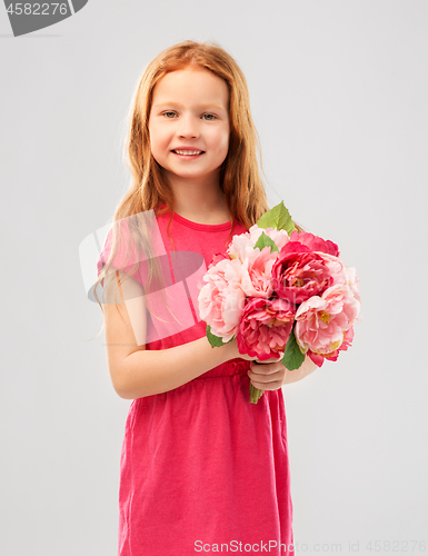 Image of happy red haired girl with flowers