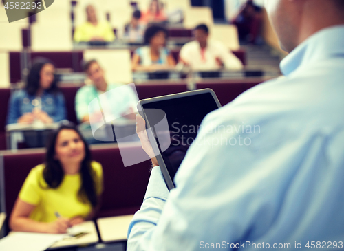 Image of teacher with tablet pc and students at lecture