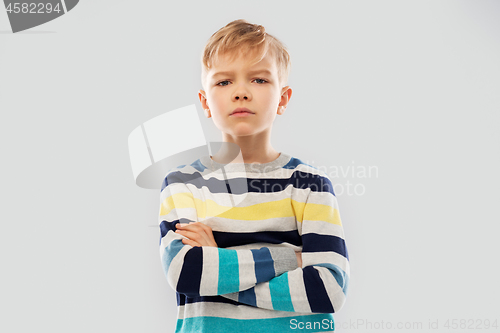 Image of little boy in striped pullover with crossed arms