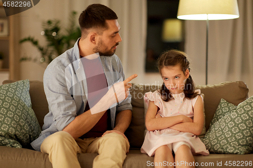 Image of upset or feeling guilty girl and father at home