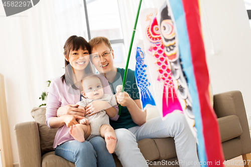 Image of mixed-race family with koinobori carp streamer