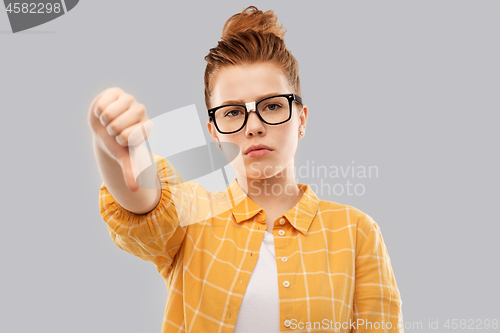 Image of red student girl in glasses showing thumbs down
