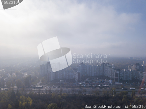 Image of Foggy morning above city district.