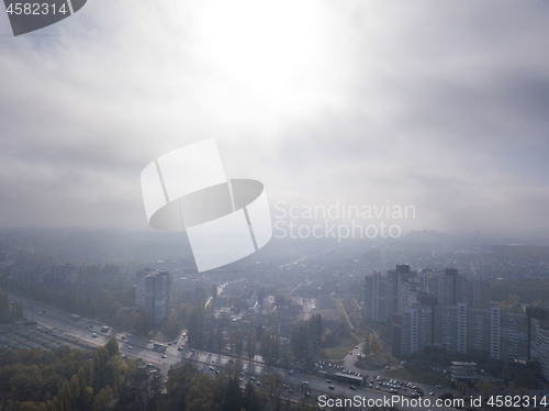 Image of Sunny foggy morning sky above residential areas.