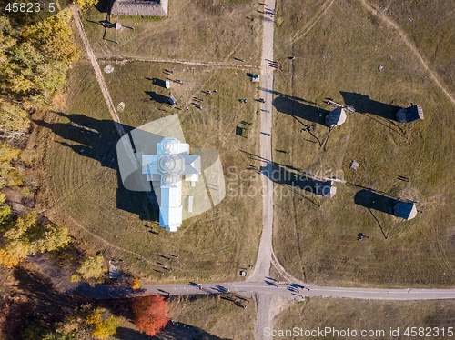 Image of Aerial view from drone above old church and windmills.