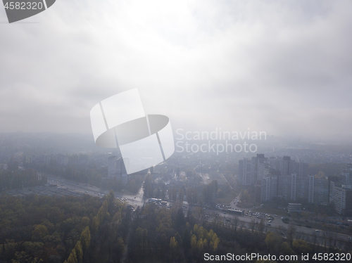 Image of Cityscape with houses on a sunny foggy sky background.