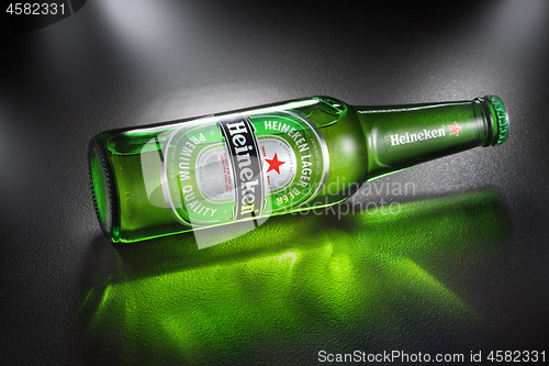 Image of UKRAINE, KYIV - APRIL 02, 2014. Bottle of Heineken Lager Beer with reflection. Heineken is the flagship product of Heineken International