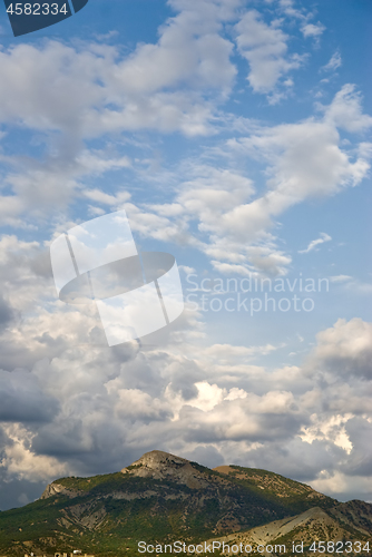 Image of Blue sky with clouds and mountains in a summer day.