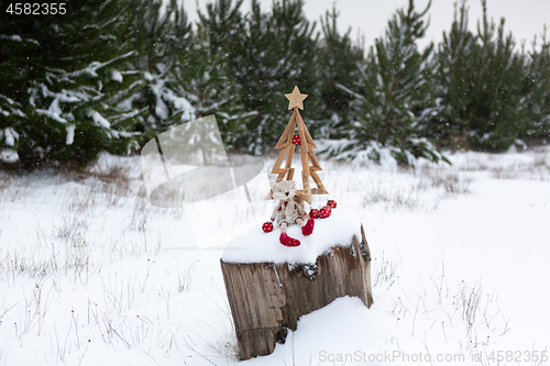 Image of Christmas tree and Christmas decorations in snowy landscape