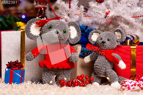 Image of Two homemade plush mice under the Christmas tree with gifts