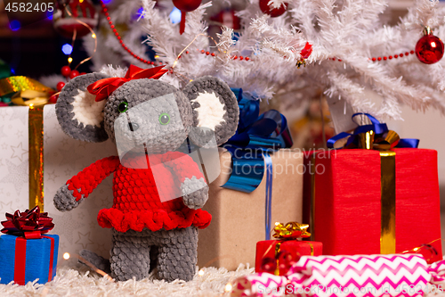 Image of Plush mouse together with gifts under the Christmas tree