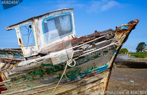 Image of Old wooden boat hull with decayed wood, peeling paint