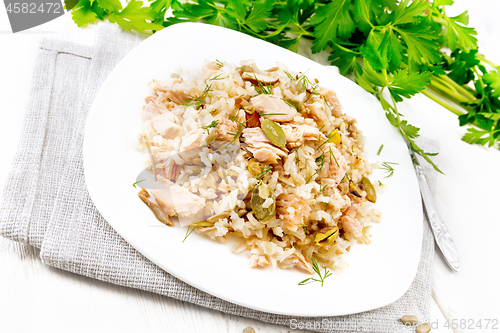 Image of Salad of salmon and rice in plate on light board