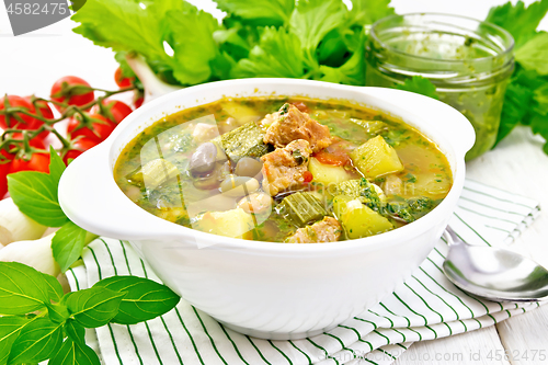 Image of Soup with pisto sauce in bowl on white board