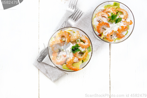 Image of Salad with shrimp and avocado in two glasses on table top