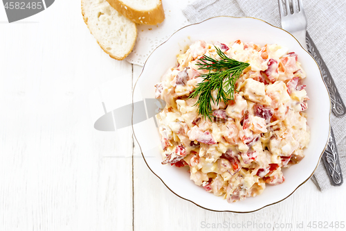 Image of Salad with chicken and vegetables in plate on board top