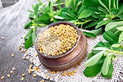 Image of Fenugreek in bowl with leaves on wooden board