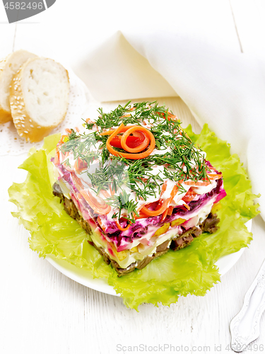 Image of Salad with beef and vegetables on wooden table